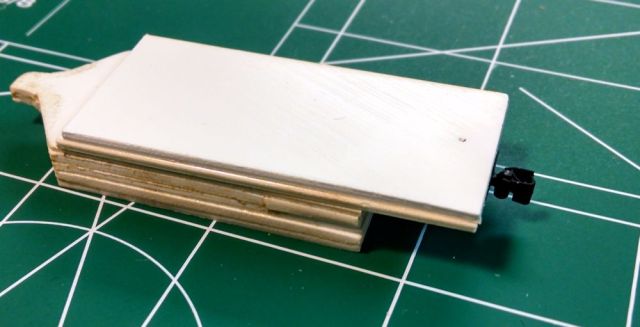 On the left is a tab for sliding under cars to verify that the body of a car is at the proper height.  At right, a KD-714 HOn3 coupler has been added.